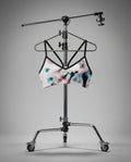 Tie-dye sports bra on a stand against a gray background