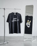 Two black t-shirts with different designs on a rack and mirror.