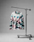 Tie-dye hoodie on a hanger attached to a metal stand against a gray background